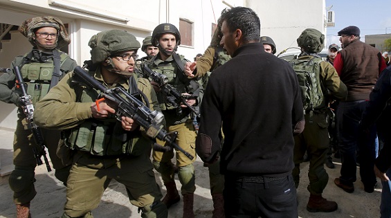 Iraeli soldiers argue with Palestinian villagers  in the West Bank village of Duma near Nablus March 20, 2016.