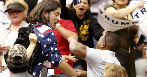 A member of the audience (R) throws a punch at a protester as Republican Presidential candidate Donald Trump speaks during a campaign event in Tucson, Arizona March 19, 2016.
