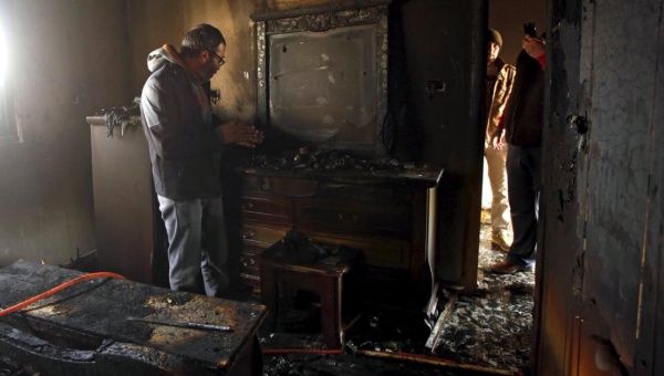 A Palestinian man inspects the damage to the torched house of Ibrahim Dawabsheh, the key witness in the July arson attack, in the West Bank village of Duma March 20, 2016. 