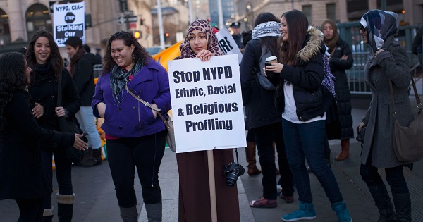 A woman holds a sign protesting the NYPD programme during a rally at Foley Square in New York.