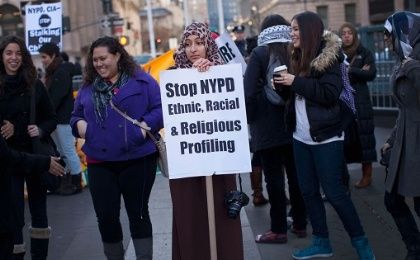 A woman holds a sign protesting the NYPD programme during a rally at Foley Square in New York.