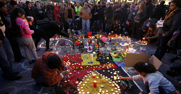 People gather around a memorial in Brussels following bomb attacks in Brussels, Belgium.