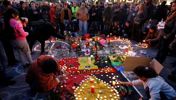 People gather around a memorial in Brussels following bomb attacks in Brussels, Belgium.