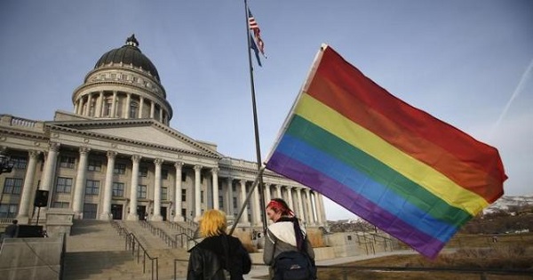 Corbin Aoyagi (L) and Jerusha Cobb walk to join supporters of same-sex marriage rally at Utah's State Capitol building in Salt Lake City, Utah January 28, 2014.