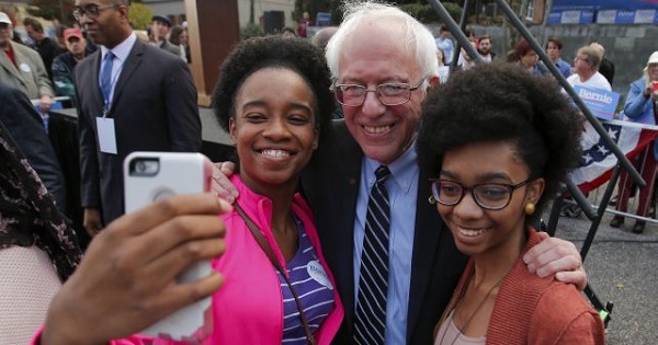 Bernie Sanders and two supporters outside the Columbia Democratic Party headquarters.