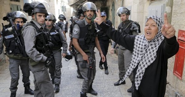 Israeli policemen prevent a Palestinian women from entering the Temple Mount, September 14, 2015.