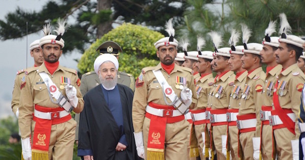 Iranian President Hassan Rouhani reviews the guard of honor at the Prime Minister's house in Islamabad, Pakistan, in this March 25, 2016 handout photo.