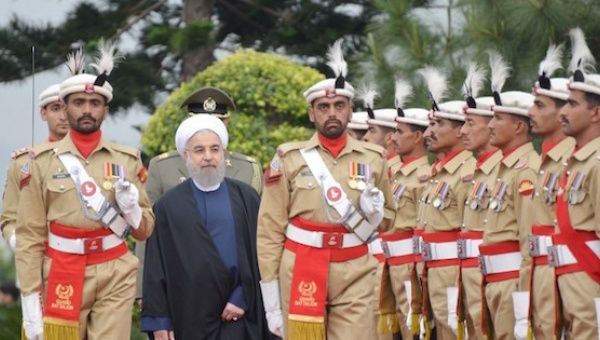 Iranian President Hassan Rouhani reviews the guard of honor at the Prime Minister's house in Islamabad, Pakistan, in this March 25, 2016 handout photo.
