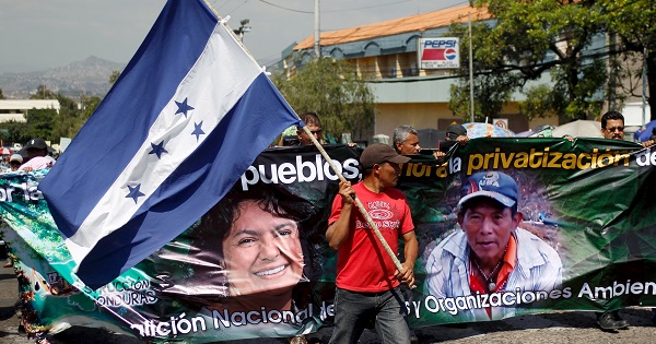 An indigenous man holds an Honduran national flag during a protest to demand justice for slain environmental rights activist Berta Caceres in Tegucigalpa, Honduras, March 17, 2016.