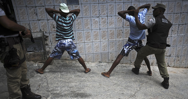 Police search youths for weapons and drugs while on patrol in the Nordeste de Amaralina slum complex in Salvador, Bahia State, March 28, 2013.