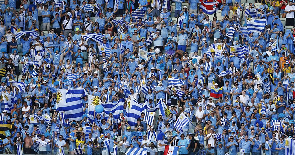 Uruguay's fans cheer before the start of the Group D soccer match between Uruguay and Costa Rica in Fortaleza on June 14, 2014