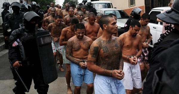 Members of the Mara Salvatrucha gang are guarded by policemen upon their arrival at the jail in Quezaltepeque, El Salvador, March 29, 2016.