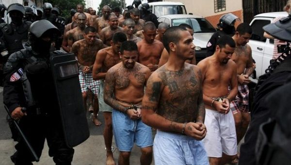 Members of the Mara Salvatrucha gang are guarded by policemen upon their arrival at the jail in Quezaltepeque, El Salvador, March 29, 2016. 