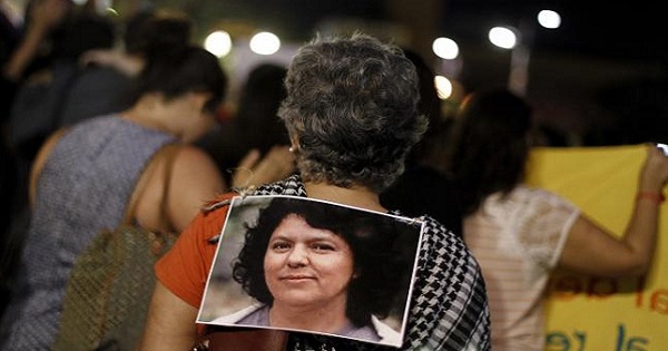 An activist wears a photo of slain environmental rights activist Berta Caceres during a protest to mark International Women's Day March 8, 2016.