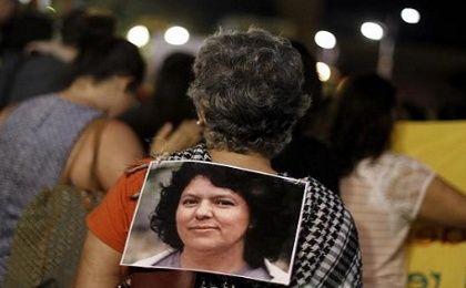 An activist wears a photo of slain environmental rights activist Berta Caceres during a protest to mark International Women's Day March 8, 2016.