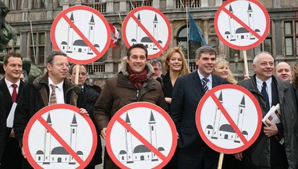 Members of several European right-wing parties pose with anti-Muslim signs, Antwerp, Belgium.