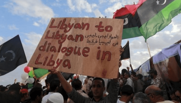 A man holds a sign during a protest against candidates for a national unity government proposed by U.N. envoy for Libya Bernardino Leon, in Benghazi, Libya Oct. 23, 2015.
