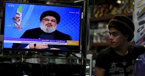A youth watches Lebanon's Hezbollah leader Sayyed Hassan Nasrallah speaking on television inside an electronics shop in the port city of Sidon.