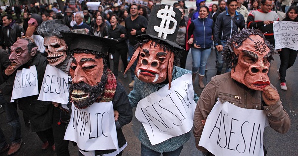 Activists protest state complicity in the case of the 43 Ayotzinapa students, two months after they were forcibly disappeared in September 2014.