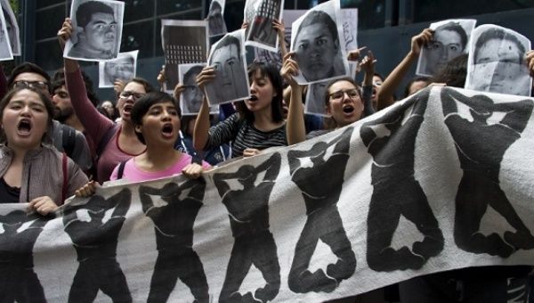 Students protest in front of the attorney general’s office in Mexico City during a protest over the disappearance of 43 Ayotzinapa students in Iguala, Guerrero. 