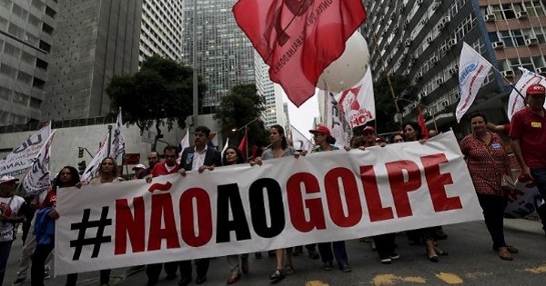 People with a banner that reads “No to the coup” attend a protest against the impeachment proceedings against President Dilma Rousseff, Brazil.