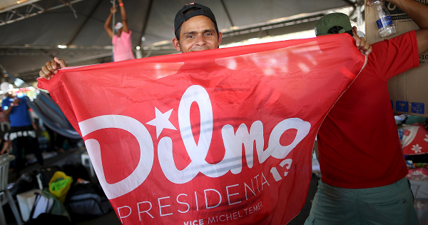 A member of the Landless Workers Movement (MST) shows a flag in support of Brazil's President Dilma Rousseff inside a tent at the camp, ahead of the impeachment process vote of Rousseff in the lower house in Brasilia, Brazil, April 15, 2016