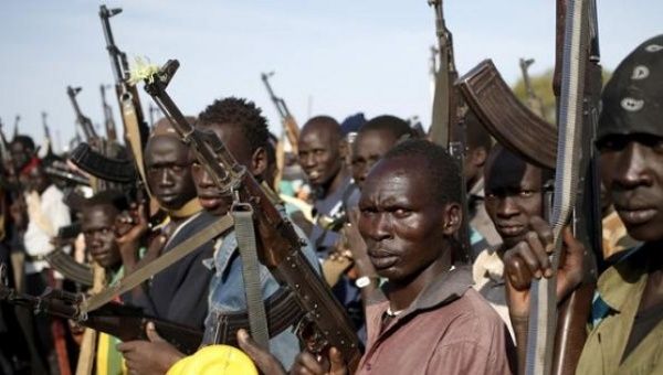 South Sudanese fighters hold their weapons. 