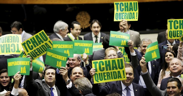 Members of Congress in support of Rousseff's impeachment hold placards reading 