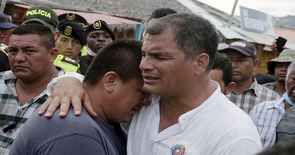 Ecuador's President Rafael Correa (R) embraces a resident after the earthquake, which struck off the Pacific coast, in the town of Canoa, Ecuador April 18, 2016.