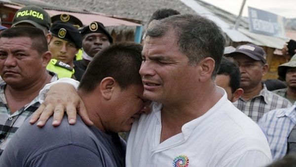 Ecuador's President Rafael Correa (R) embraces a resident after the earthquake, which struck off the Pacific coast, in the town of Canoa, Ecuador April 18, 2016. 