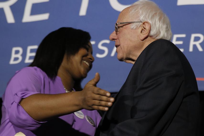 Bernie Sanders is embraced by Erica Garner, daughter of the late Eric Garner, at a town hall in Columbia, South Carolina, on Feb. 16.