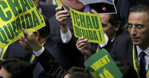 Members of Brazil's lower house in favor of the impeachment of President Dilma Rousseff hold up signs reading 