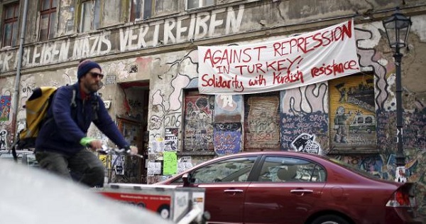 A banner hangs on a squatter house in Berlin, Germany, April 13, 2016. The words read 'Against repression in Turkey! Solidarity with Kurdish resistance'.