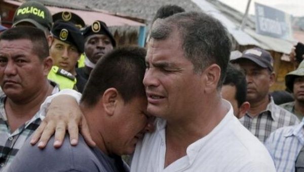 Ecuador's President Rafael Correa embraces a resident in the town of Canoa two days after earthquake, April 18, 2016.