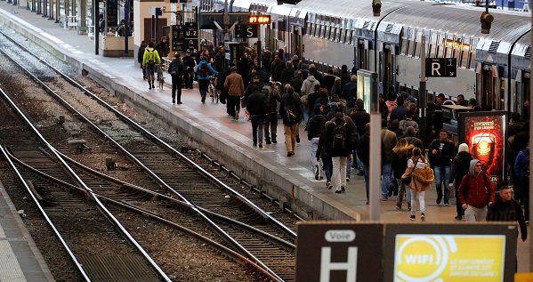 People walk along a train platform inside the Gare de Lyon railway station in Paris, France.