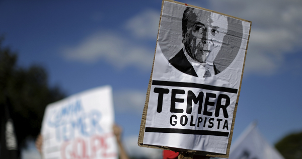 Members of social movements hold signs during a protest against Brazil's Vice President Michel Temer in front of Jaburu Palace in Brasilia, Brazil April 23, 2016.