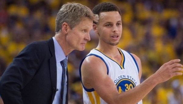 Golden State Warriors head coach Steve Kerr talks to guard Stephen Curry during a game.
