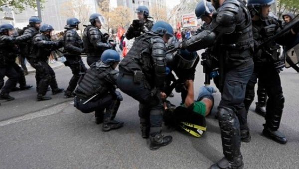 French police wrestle a protester to the ground as rallies against labor reforms take place in various cities across the country.