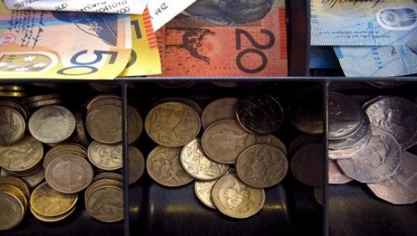 Australian dollar notes and coins can be seen in a cash register at a store in Sydney, Australia, February 11, 2016.