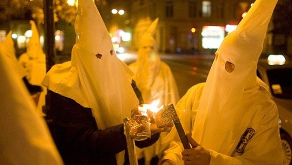 Members of the KKK light a fire in this file photo.