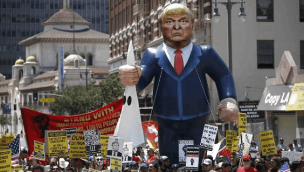 People march with an inflatable effigy of Republican presidential candidate Donald Trump during an immigrant rights May Day rally in Los Angeles, California, U.S., May 1, 2016.