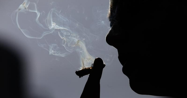 A man smokes marijuana during a rally for the legalization of marijuana in Toronto, April 20, 2010.