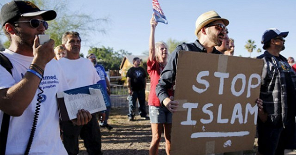 A demonstrator shouts and carries a “Stop Islam” sign during a “Freedom of Speech Rally Round II” outside the Islamic Community Center of Phoenix.