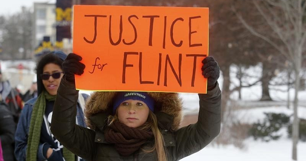 Demonstrators protest over the Flint, Michigan contaminated water crisis outside of the venue where the Democratic U.S. presidential candidates' debate was being held in Flint, Michigan in this March 6, 2016.