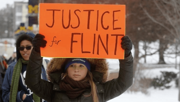 Demonstrators protest over the Flint, Michigan contaminated water crisis outside of the venue where the Democratic U.S. presidential candidates' debate was being held in Flint, Michigan in this March 6, 2016.