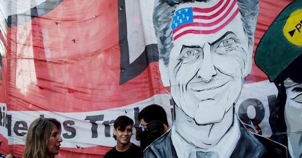 A caricature of President Macri with the U.S. flag on his forehead at a protest in Argentina.