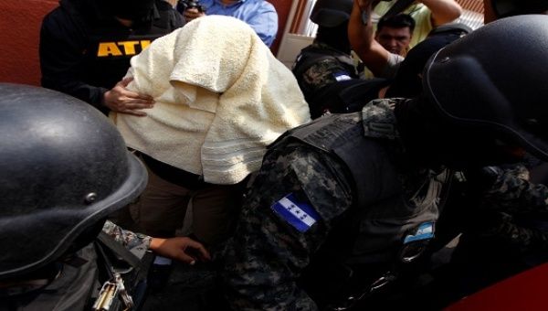 The alleged killer of environmental rights activist Berta Caceres is surrounded by members of the military police after being detained in Honduras, May 2, 2016.