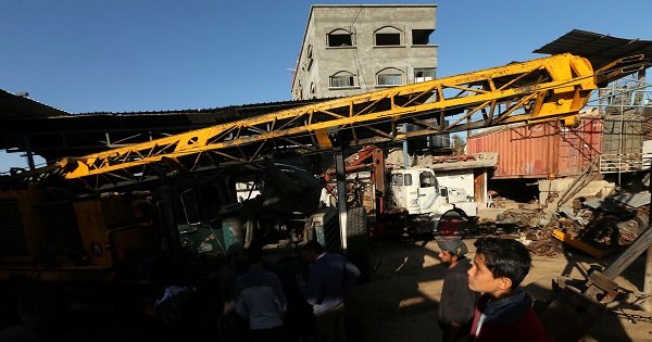 Palestinians inspect the scene of what witnesses said was an air strike on a workshop in Gaza City May 5, 2016
