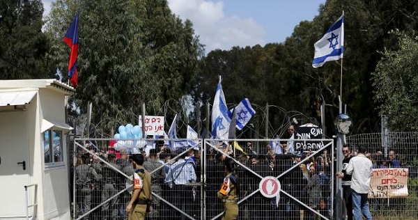 Israeli right-wing protesters outside a military court for the soldier who shot an unarmed Palestinian.