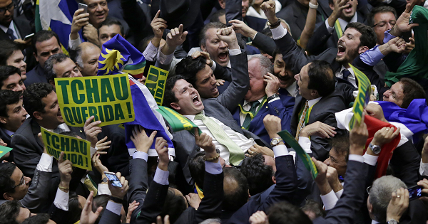 Bruno Araujo (C) celebrates after his vote in favor of the impeachment of President Dilma Rousseff was enough to confirm the process, in Brasilia.